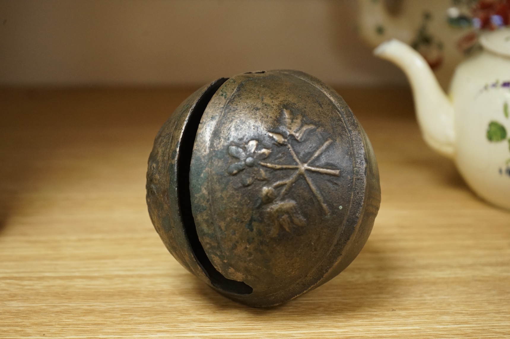 A 19th century livestock crotal bell engraved 8 1/2, 12cm wide